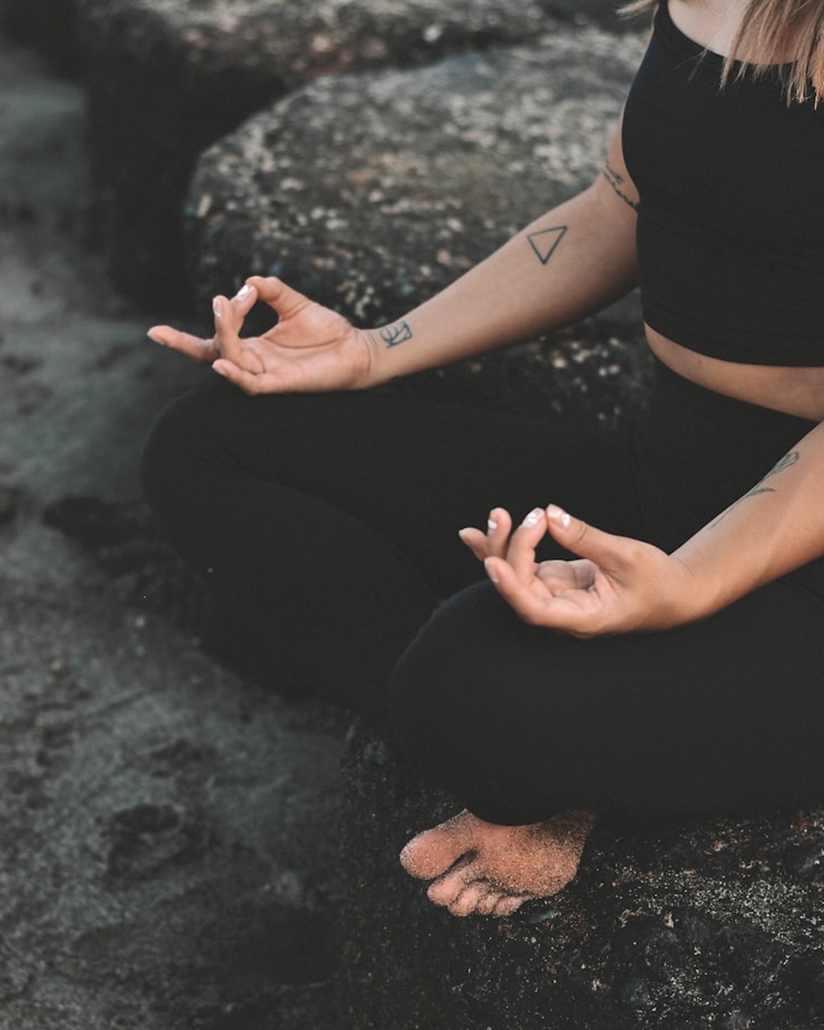 Seated lotus meditation with both hands in jnana mudra on a sun-warmed shoreline
